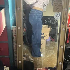 Customer in Sculpt Jeans, side view in a bedroom mirror