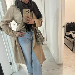 Customer wearing light-wash Sculpt Jeans with a trench coat