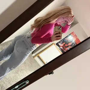 Customer wearing flared Sculpt Jeans in a bedroom mirror